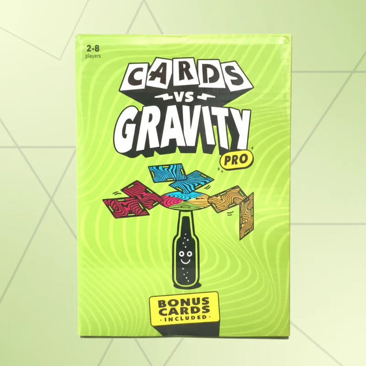 Green card game box with an illustration of cards balanced above a bottle