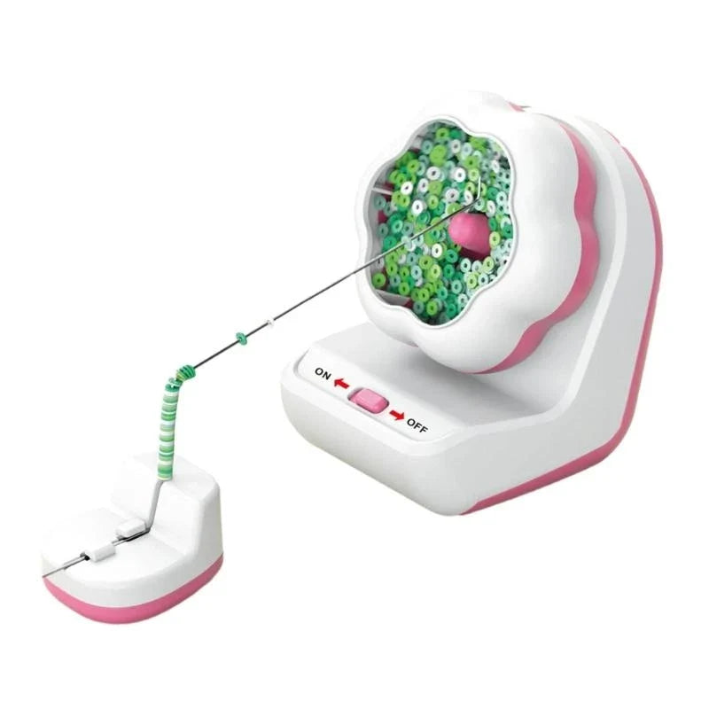 Pink-and-white bead spinner with green beads feeding onto a needle in a separate holder.