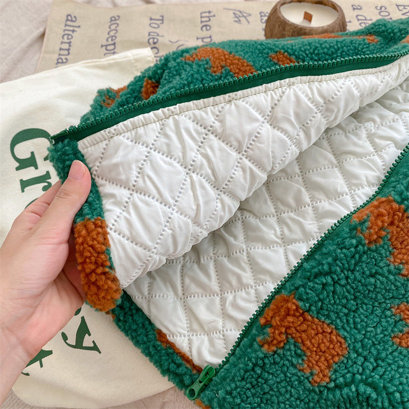 Green bear-print fleece jacket opened to reveal white quilted lining