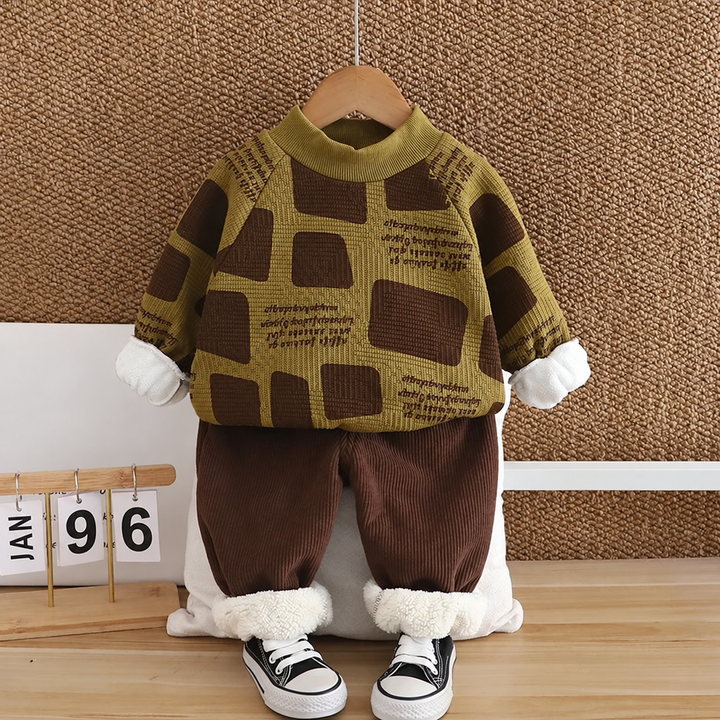 Green block-patterned sweater with brown pants and white turned-up cuffs