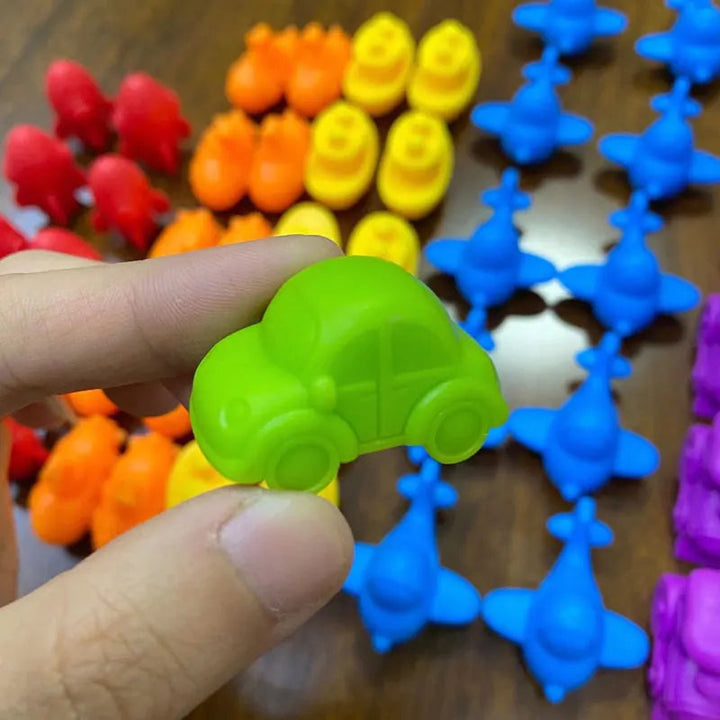 A green car counting figure held between two fingers