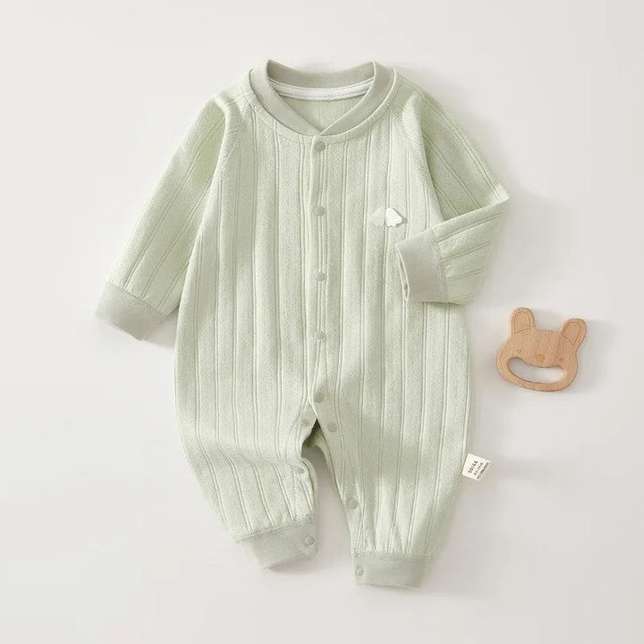 Green cotton baby romper with long sleeves, front snaps, and ribbed ankle cuffs