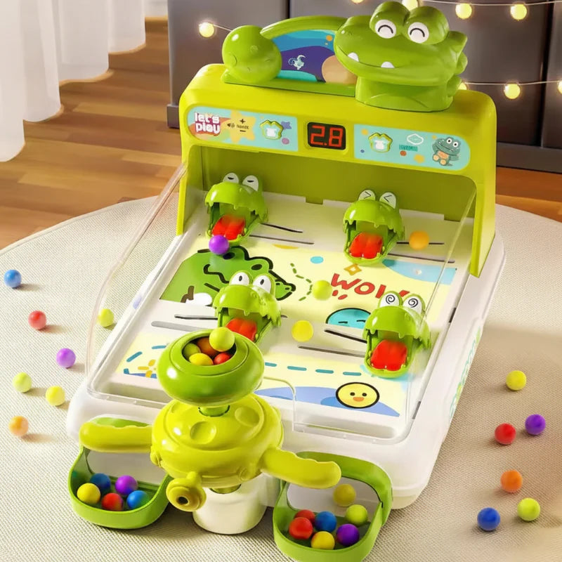 Green crocodile pinball game with colorful balls and a digital score display