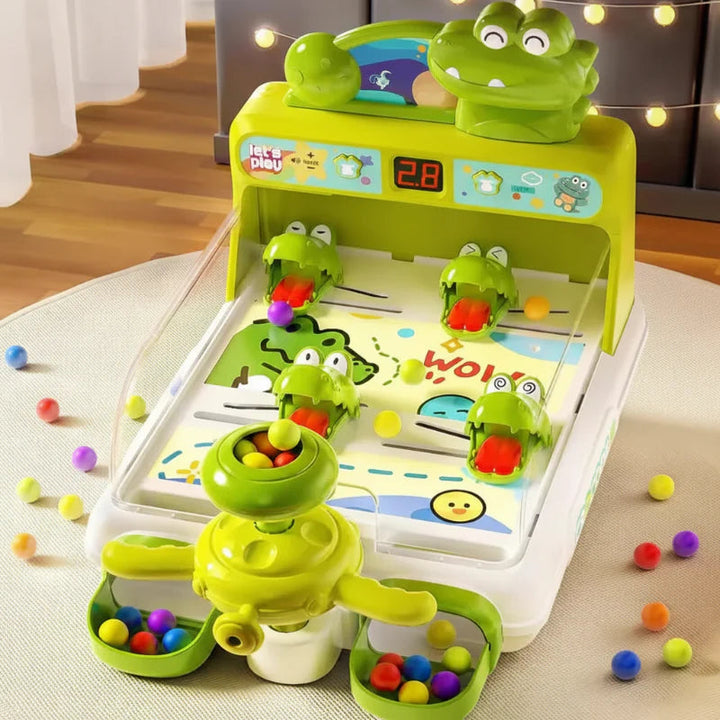 Green crocodile pinball game with colorful balls and a digital score display