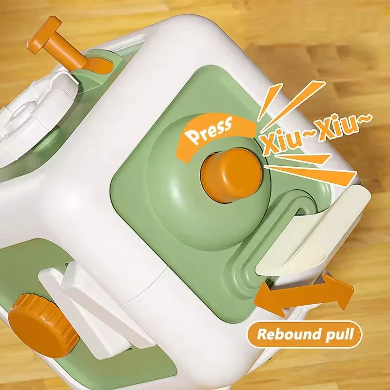 Close-up of a green cube panel with an orange push button and a pull-out tab