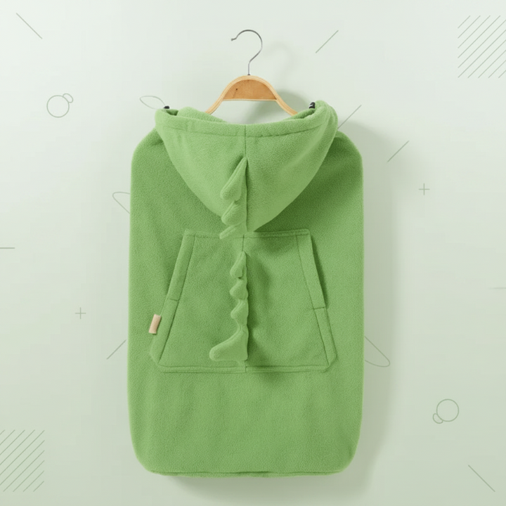 Green dinosaur baby carrier cover hanging from a hanger with its hood and pocket visible