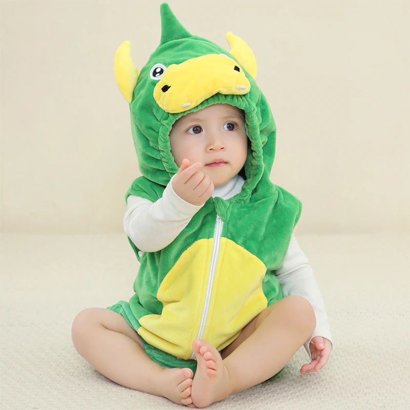 Baby in a green dinosaur onesie with a yellow belly and pointed hood