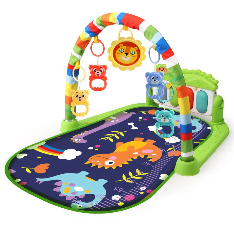 Green dinosaur baby gym with a dark play mat and colorful hanging toys