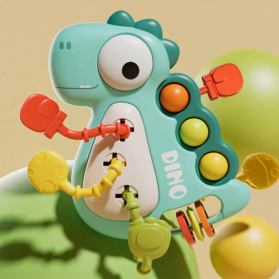 Green dinosaur pull toy with colorful cord ends, three pop bubbles and rotating rings