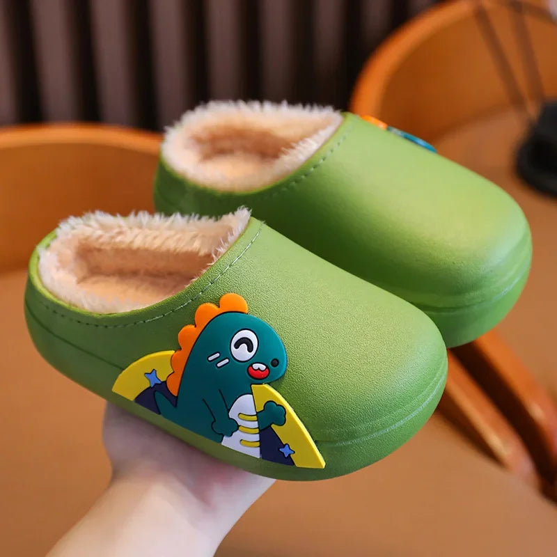 Green dinosaur slippers with rounded toes and a soft-looking beige lining