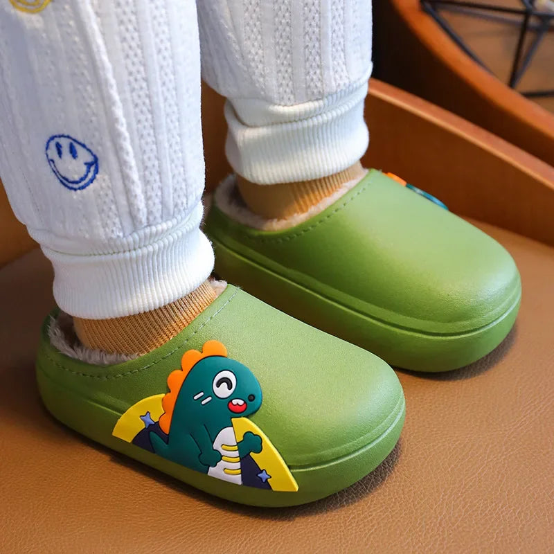 Green dinosaur slippers worn with white cuffed pants