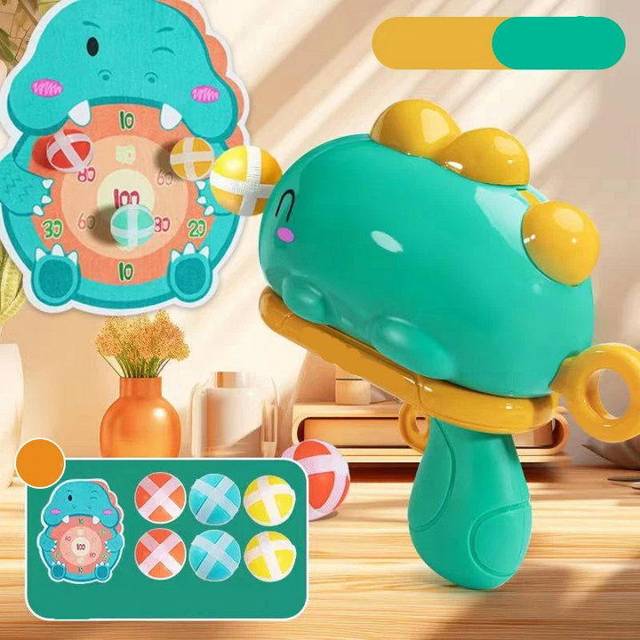 Green dinosaur ball launcher with yellow details, a numbered target, and six colorful balls