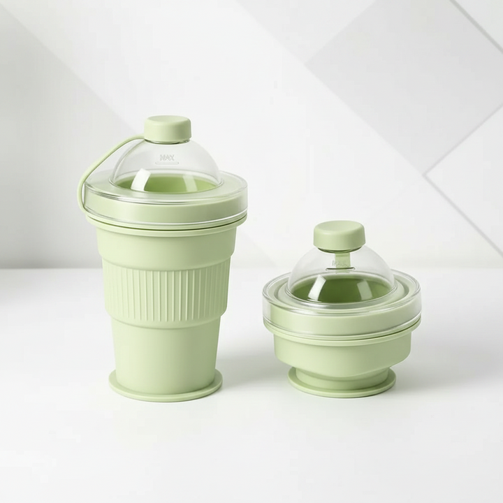 Green silicone drinking cup shown expanded and folded with clear domed lids