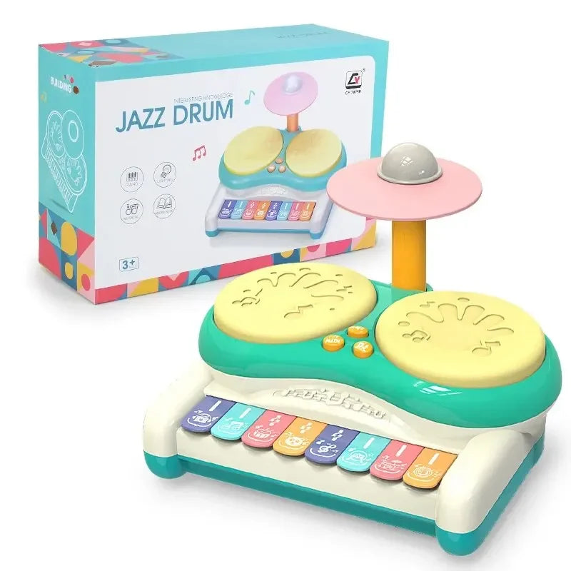 Green drum and keyboard toy with two yellow drum pads, a pink cymbal, and its retail box