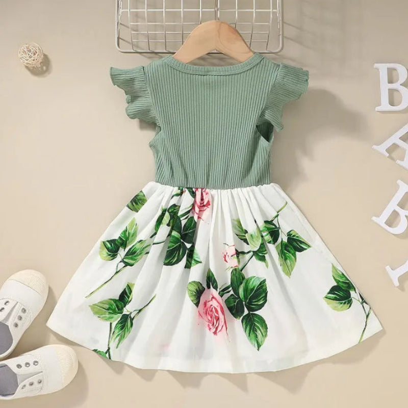 Back of the green dress showing its rib-knit bodice and gathered floral skirt