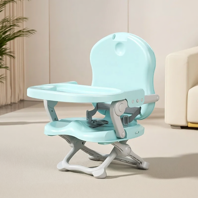 Green compact high chair with a matching tray and folding base