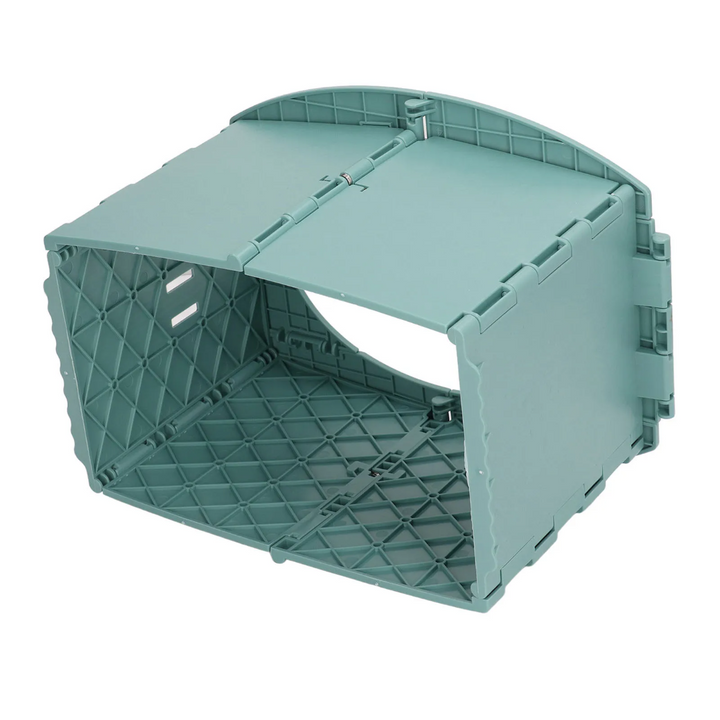 Underside view of the green potty showing its folding panels and internal structure