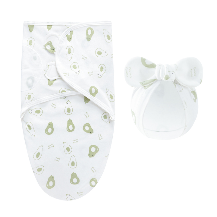White swaddle blanket and matching bow hat with a green fruit pattern