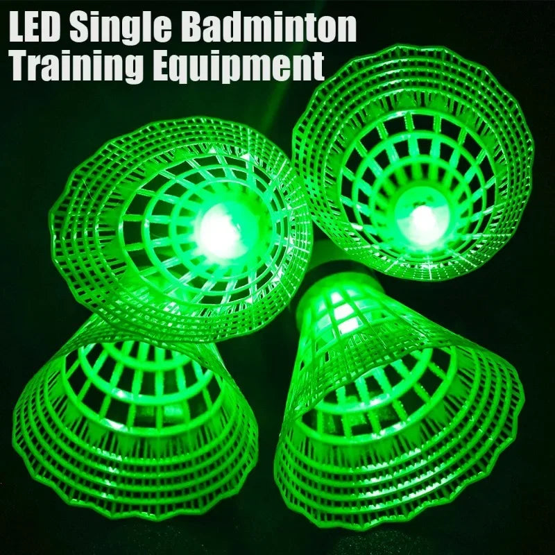 Green badminton shuttles glowing from built-in lights against a dark background