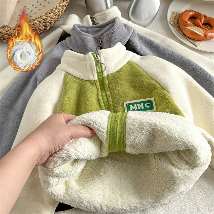 Green jacket lifted to show its cream plush fleece lining