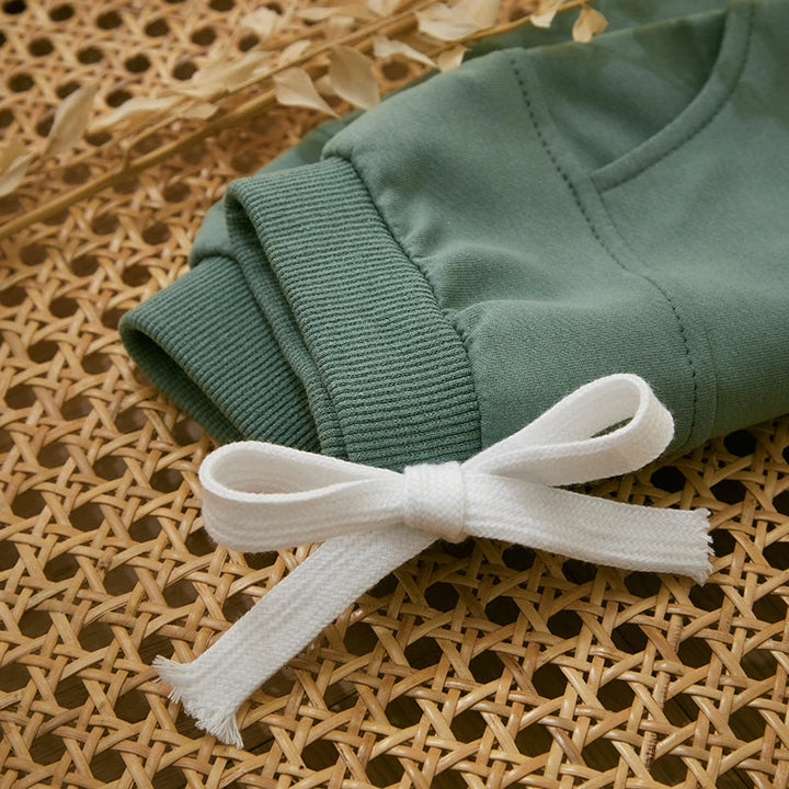 Green jogger waistband with ribbed trim and a white drawstring