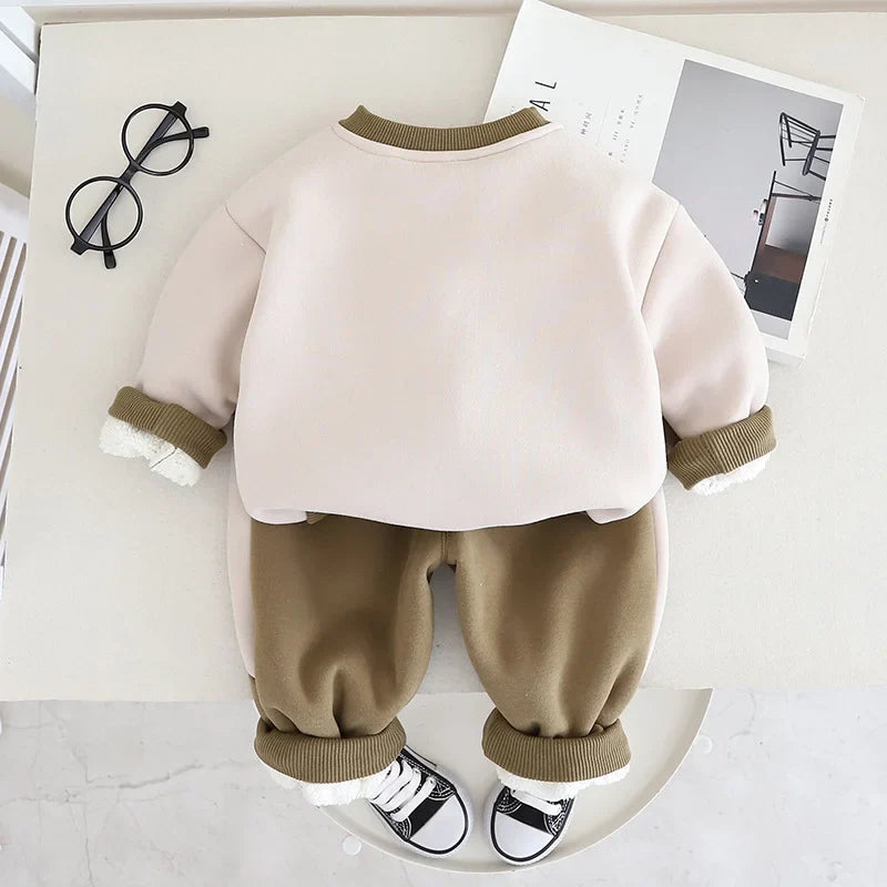 Back view of the green set with a plain cream sweater back and matching pants