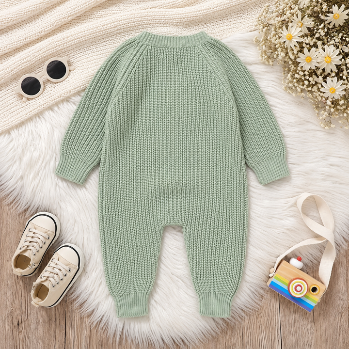 Back of a green knit baby jumpsuit with long sleeves and ribbed ankle cuffs.
