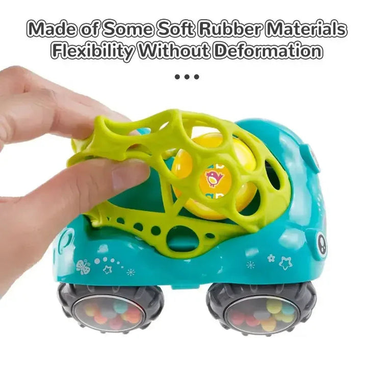 Hands squeezing the green flexible lattice top of a rattle toy car