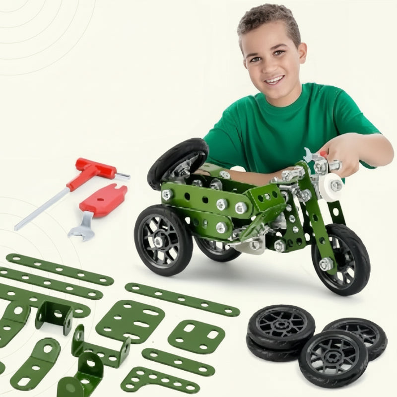 A child with a green military-style motorcycle model, loose parts, wheels, and assembly tools