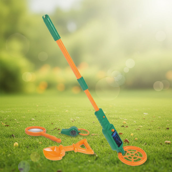 Green and orange metal detector with a shovel, magnifying glass, and compass on grass