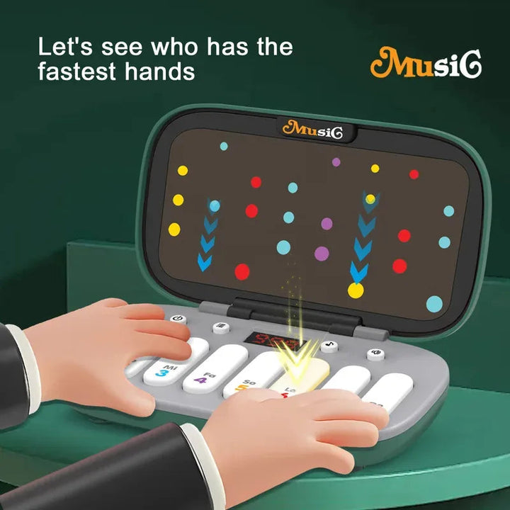 Hands pressing a green piano toy&