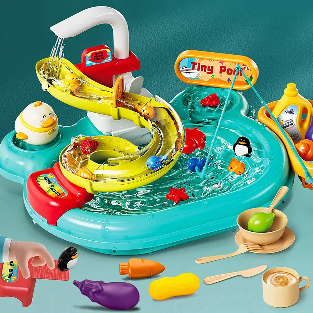 Green play kitchen sink with running water, a winding track, toy dishes, and play vegetables