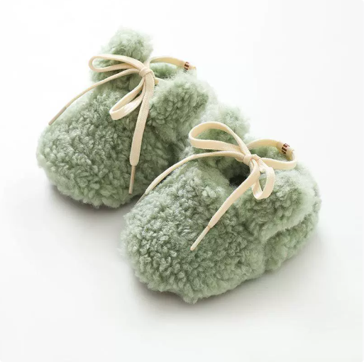 Green plush bunny baby slippers with cream bow ties