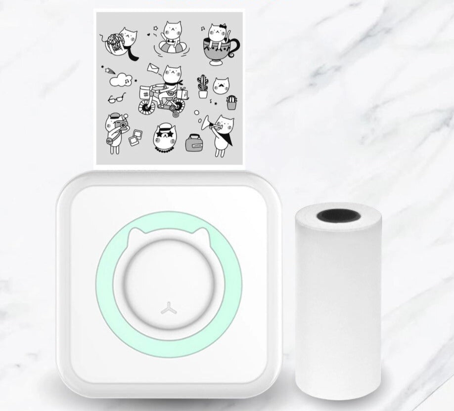 Green-accented mini printer with a paper roll and a printed sheet of cartoon cats