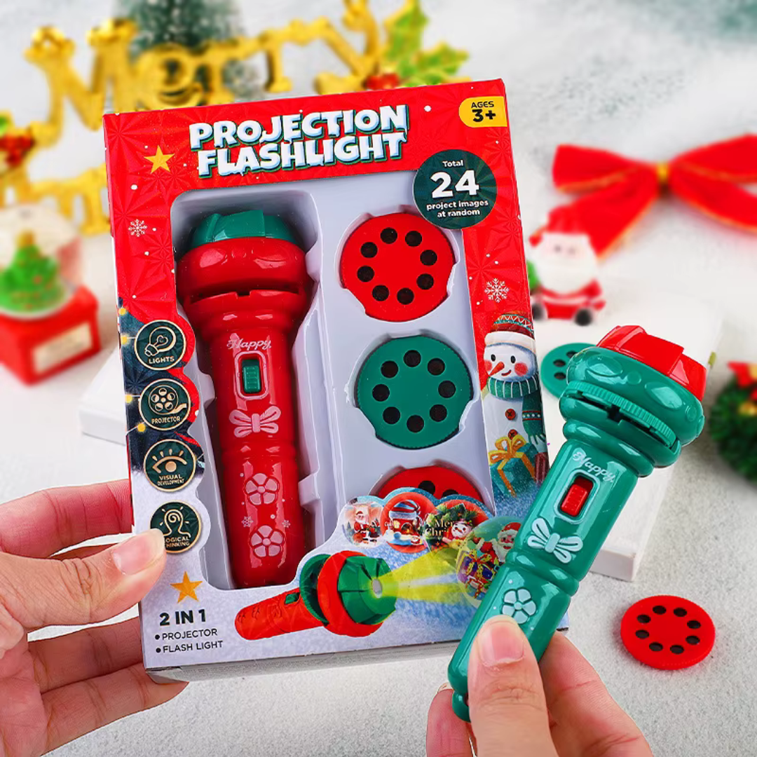 Green Christmas projection flashlight held beside its packaging and a red picture disc