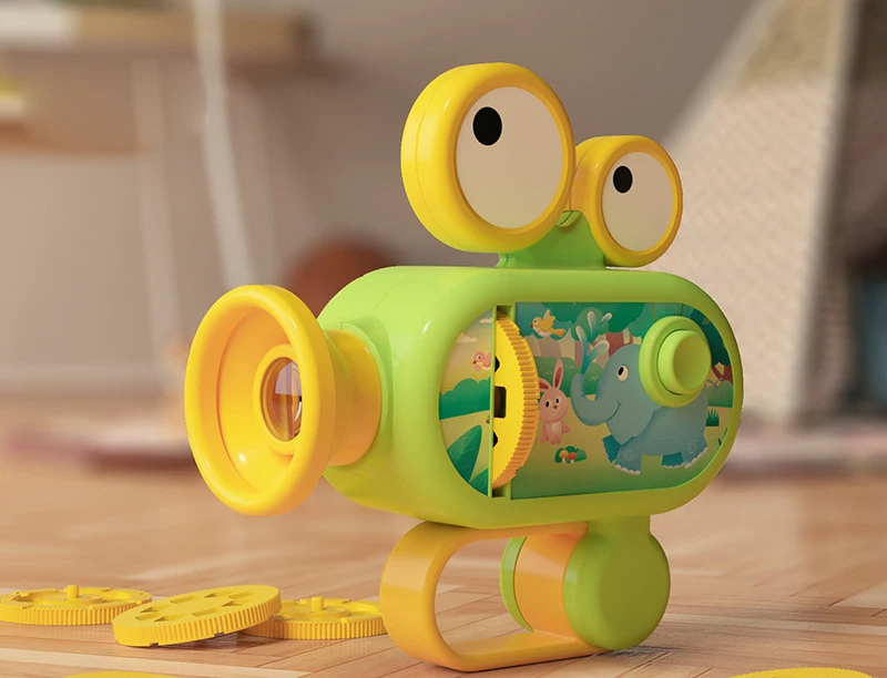 Green toy projector with yellow trim and projection slides on a wooden table