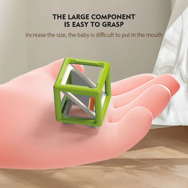 Green laser maze reflector cube resting on an open hand.