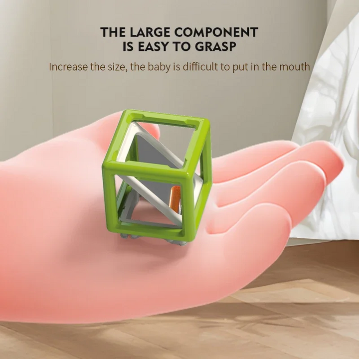 Green laser maze reflector cube resting on an open hand.