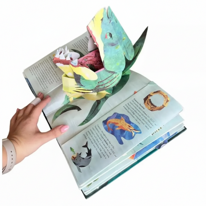 Open sea monster book with a large green shark pop-up and smaller illustrated creatures