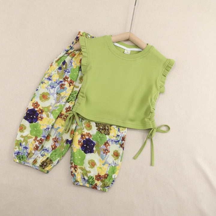 Green ruffle-trimmed top with a side tie and multicolored floral pants