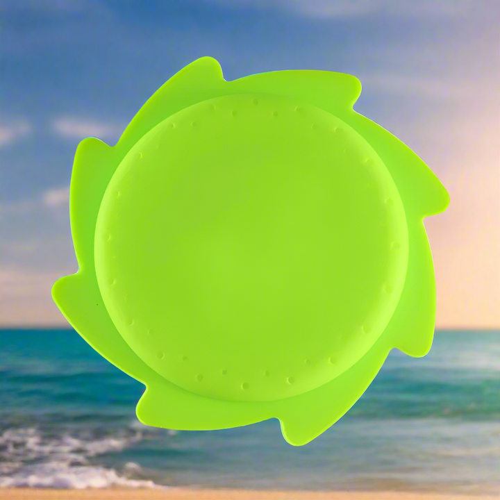 Plain green silicone water flying disc with a ring of small holes