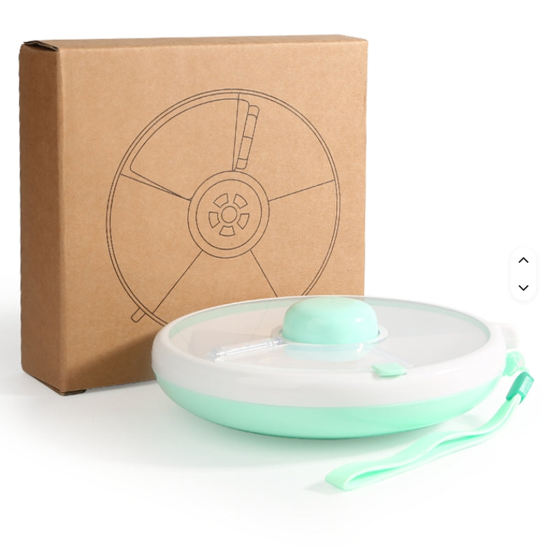 Green rotating snack box with a wrist strap beside its cardboard packaging