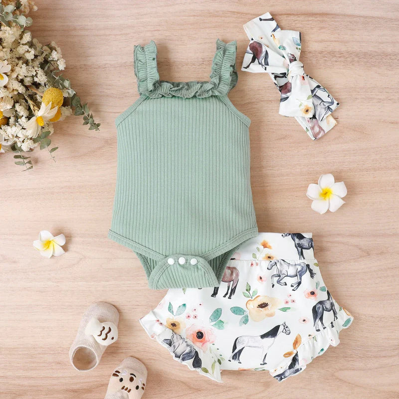 Green ribbed baby romper with snap closure, animal-print shorts and matching bow headband