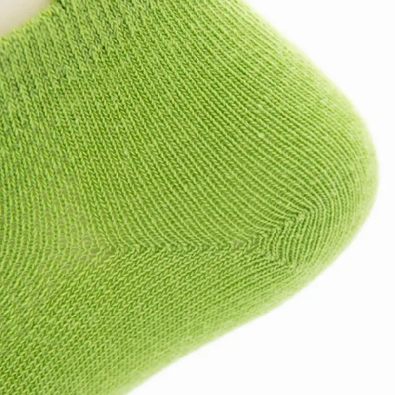 Close-up of the shaped heel and knit texture on a green sock