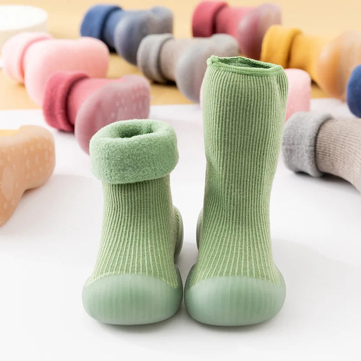 Green sock shoes showing folded and extended cuffs, with other colors in the background.
