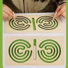 Green spiral maze board shown in use and with two wooden styluses in its center slot