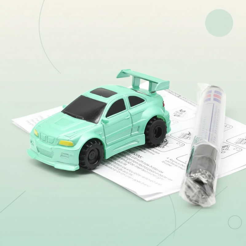 Green toy car with a rear spoiler, drawing pen, and instruction sheet
