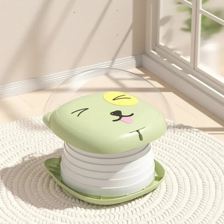 Green travel potty with the lid closed and the accordion-style body expanded