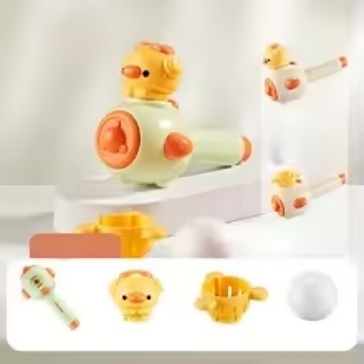 Green 2-in-1 blowing toy shown with the chick-shaped head fitted and ball basket alongside.