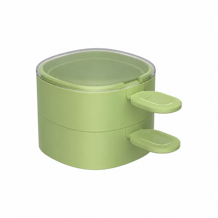 Two green ice cream molds stacked with matching spoons and a clear lid on top.